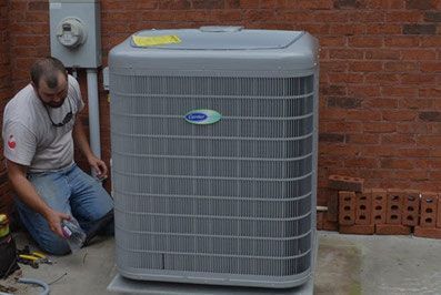A Speir technician installs a Carrier air conditioner