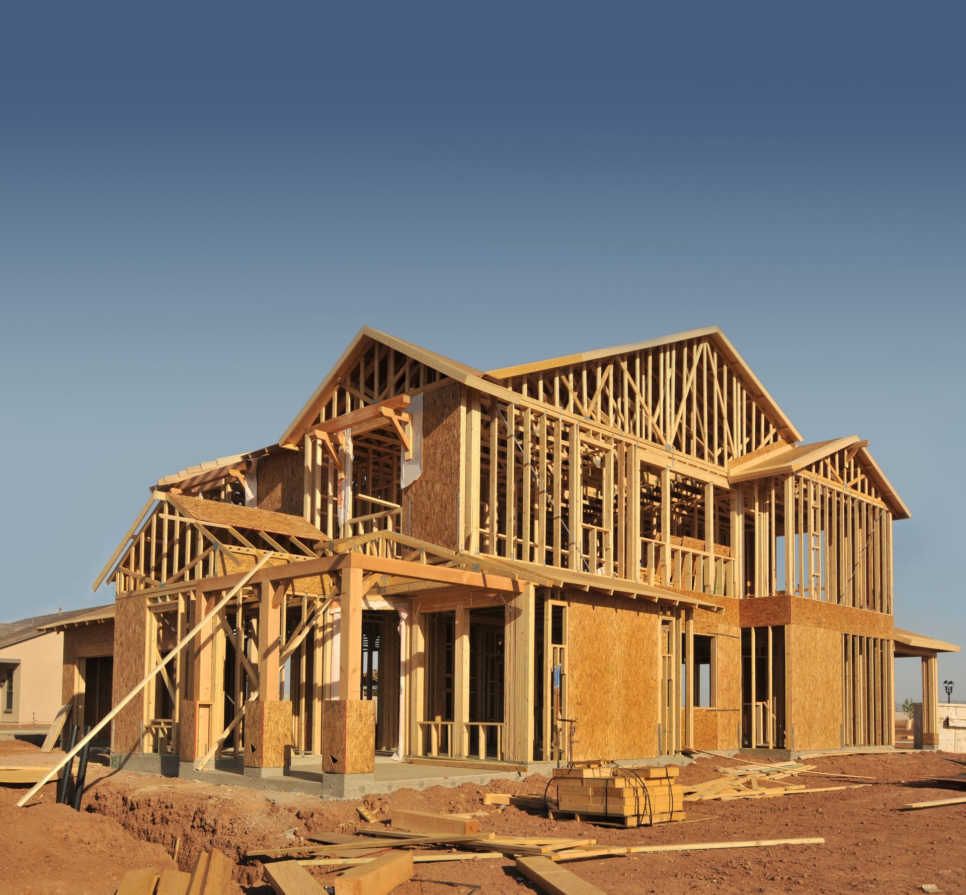 A house that is being built with a blue sky in the background