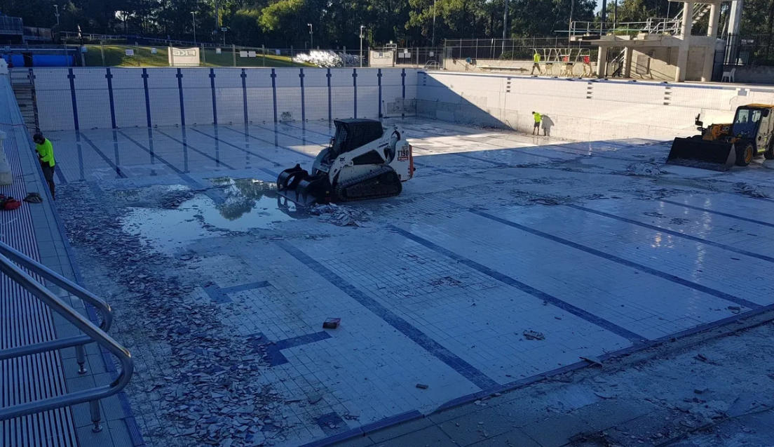 Man Renovation Empty Pool — TNT Floor Removal & Demolition in Tewantin, QLD