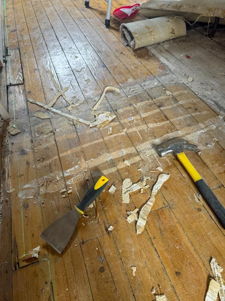 Four Pieces of Wood Are Stacked on Top of Each Other on A Wooden Floor — TNT Floor Removal & Demolition in Tewantin, QLD