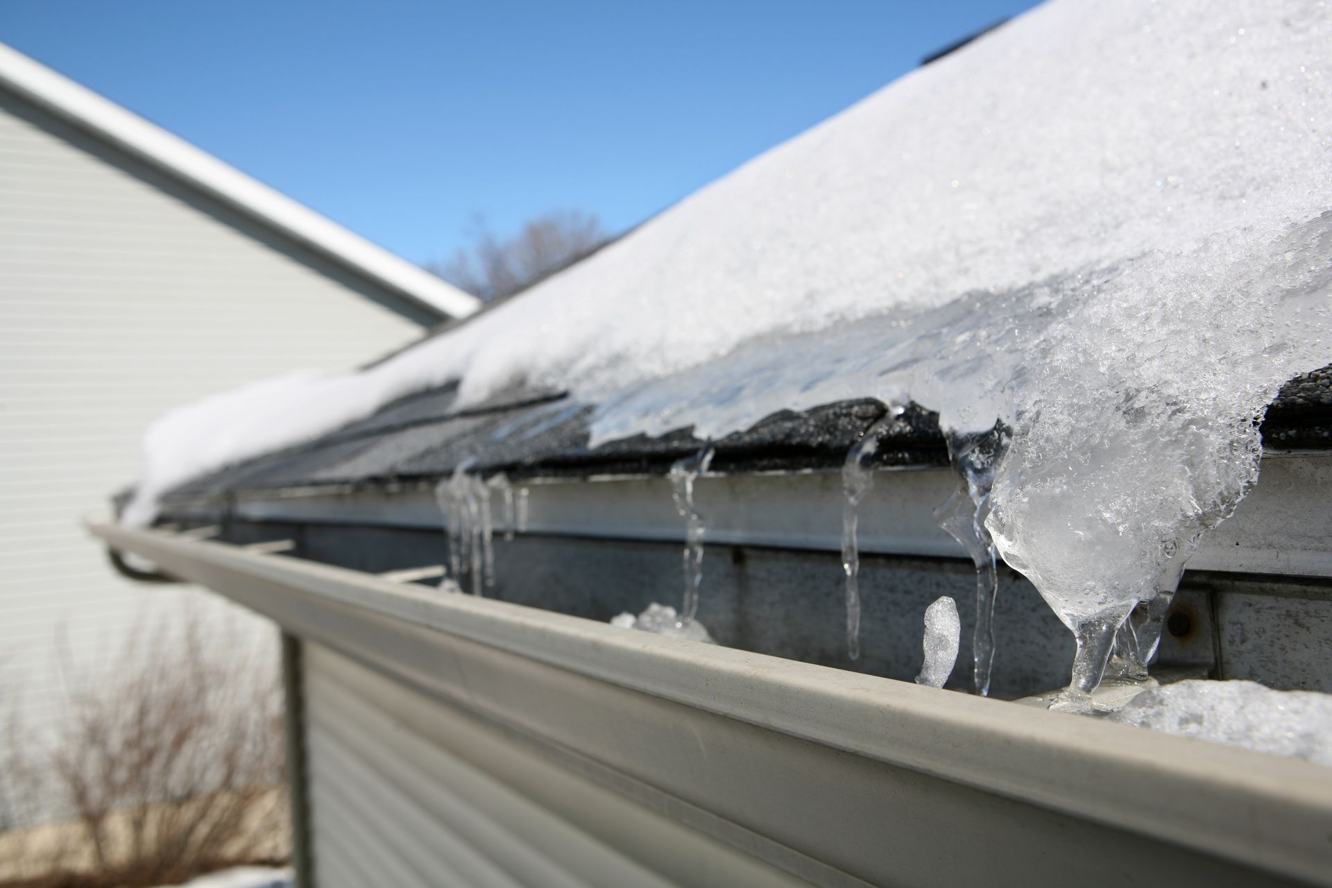 Icicles are melting on the roof of a house
