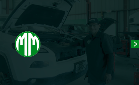 Overhead view of a dark gray roof, with a green and yellow logo featuring a stylized house and the letter 