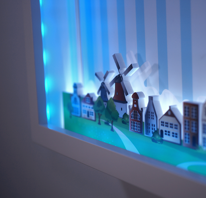 Ein Papiermodell einer Stadt mit Windmühlen und Häusern