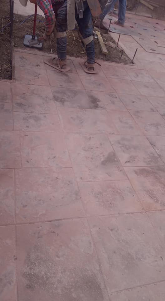 A person is standing on a tiled floor.