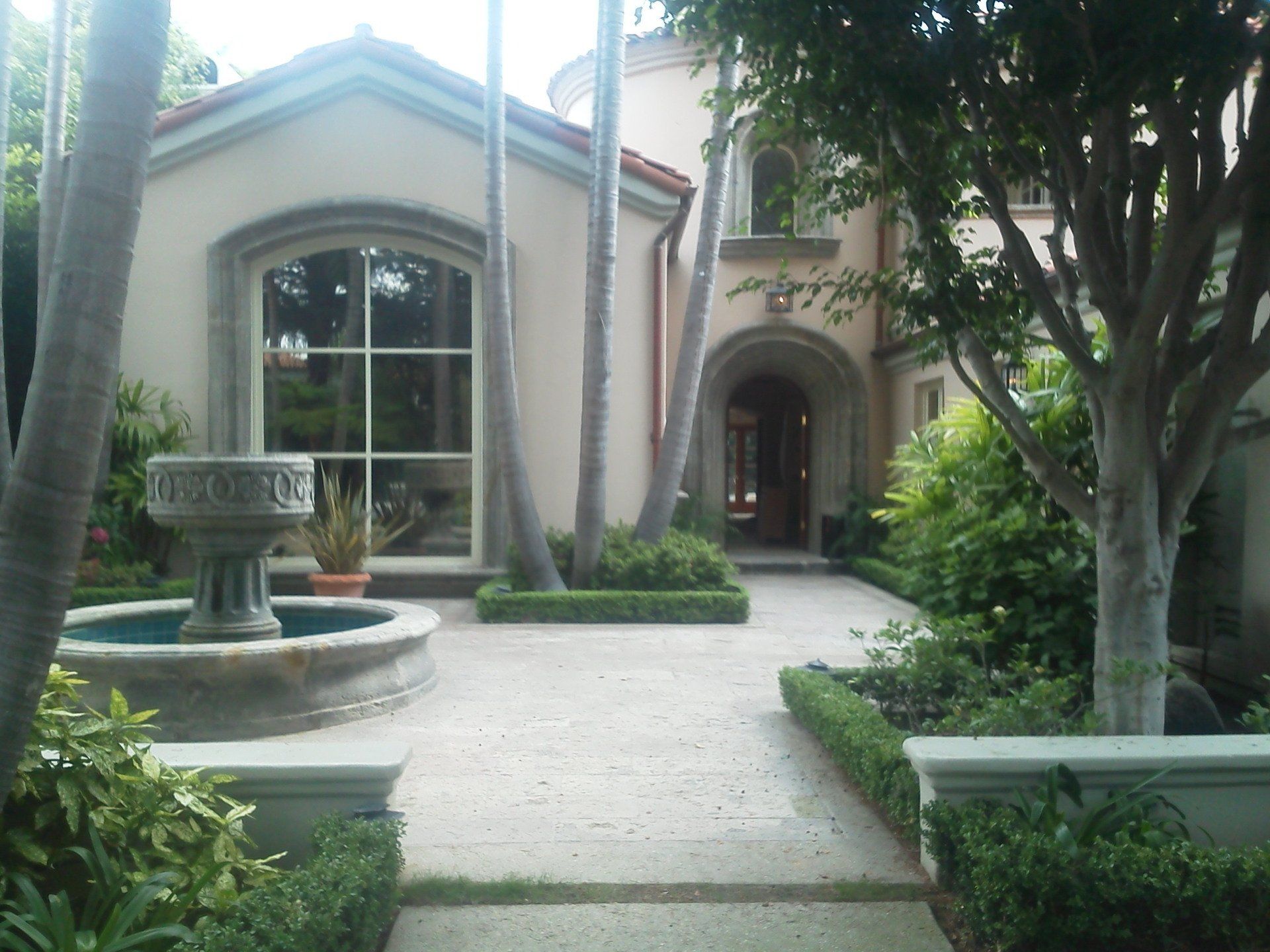 A large house with a fountain in front of it