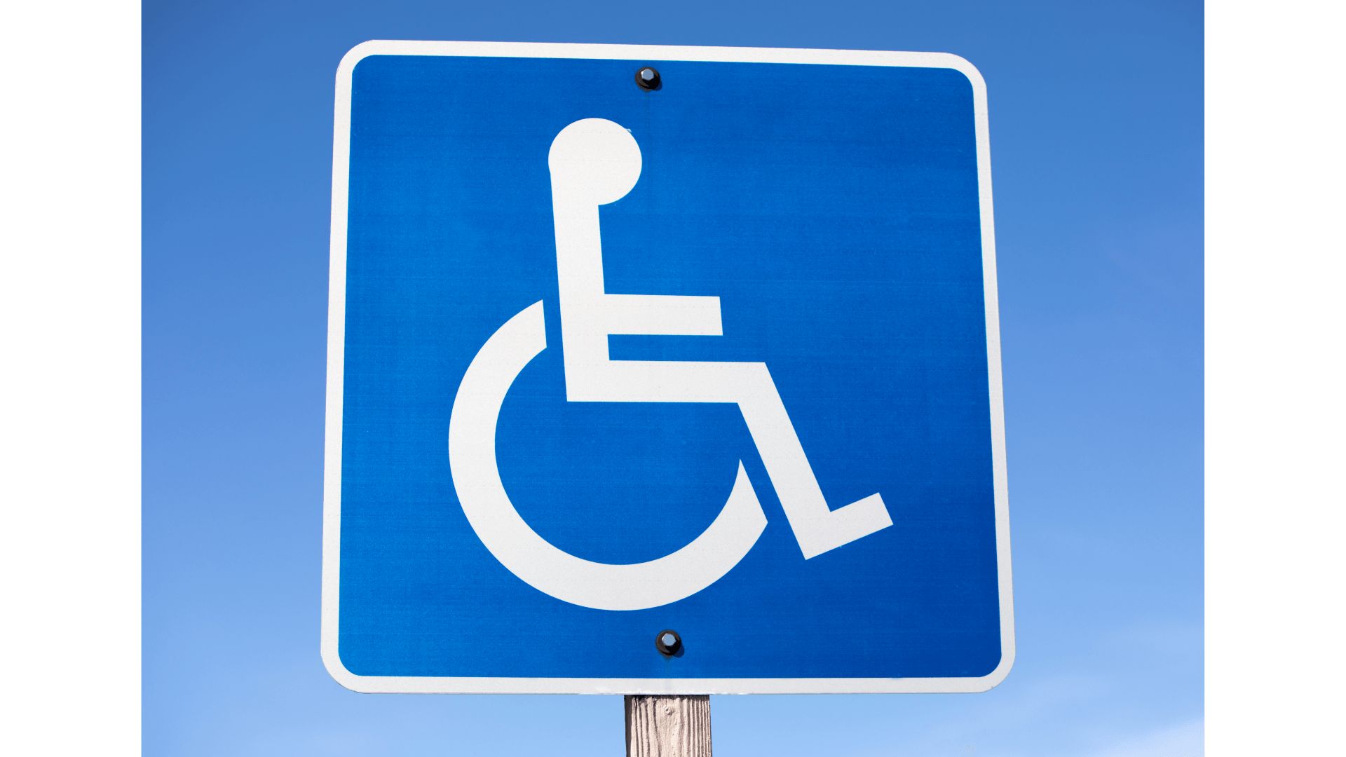 A blue handicap sign against a blue sky