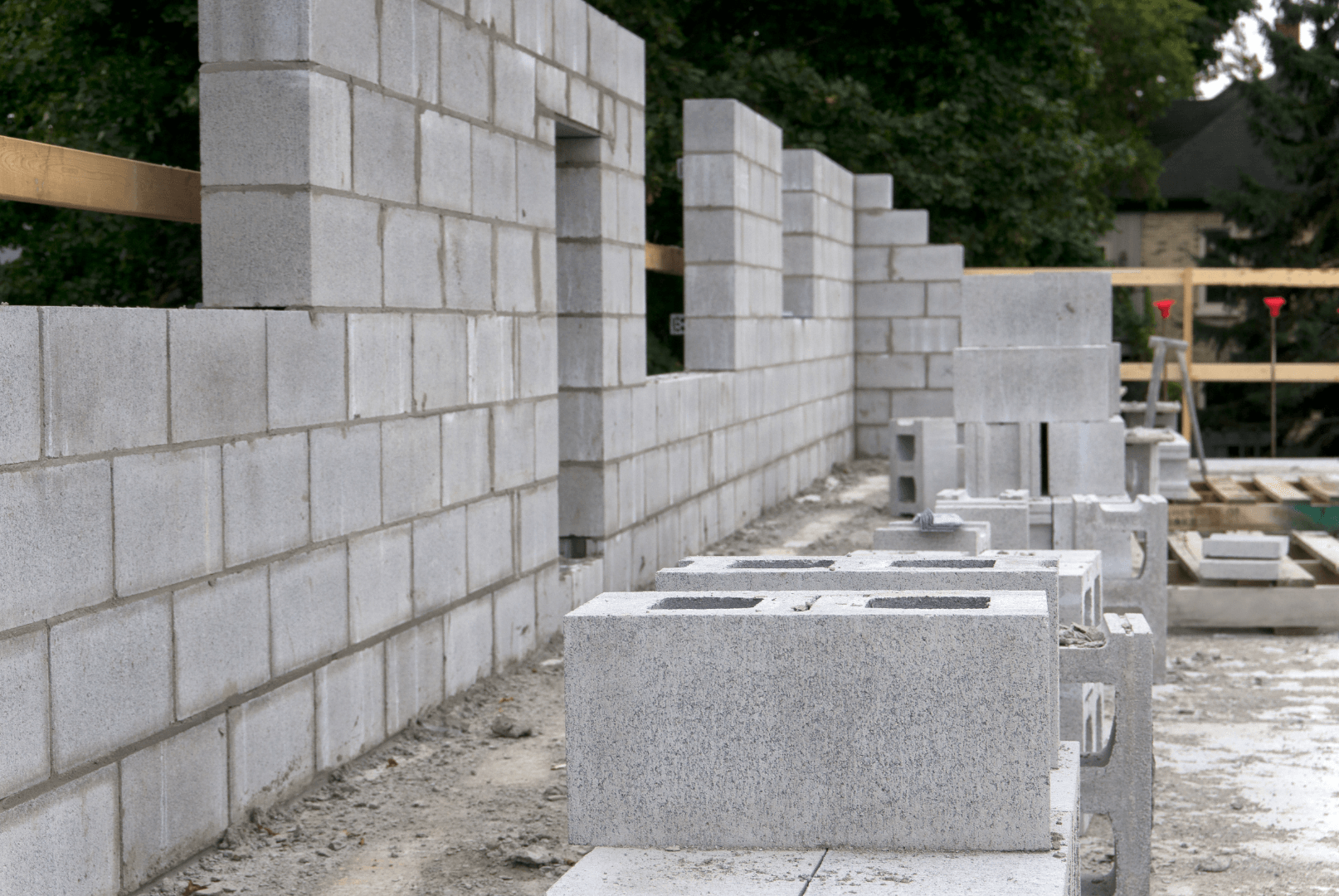 A brick wall is being built on a construction site