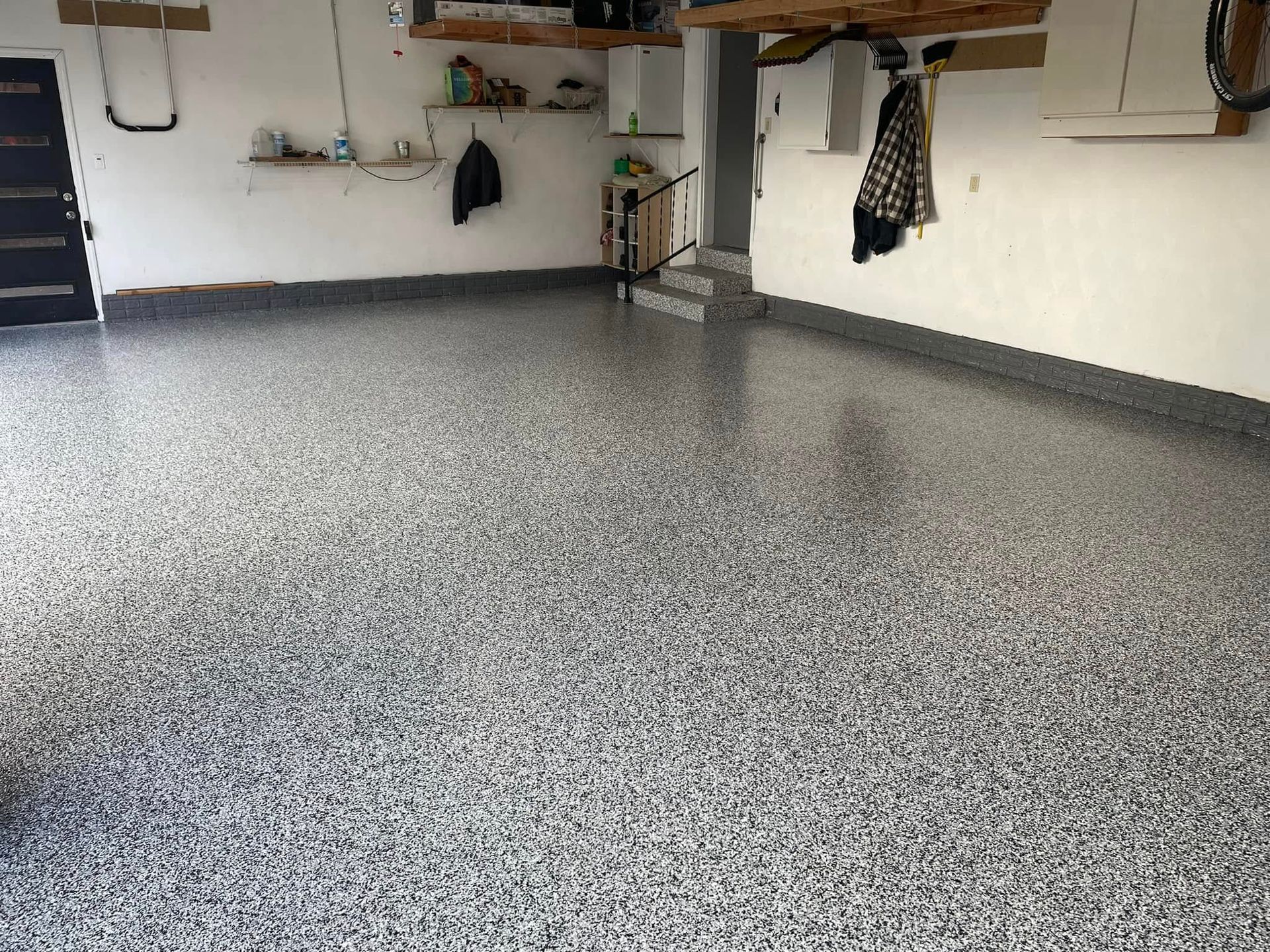 Garage with a speckled gray epoxy floor.