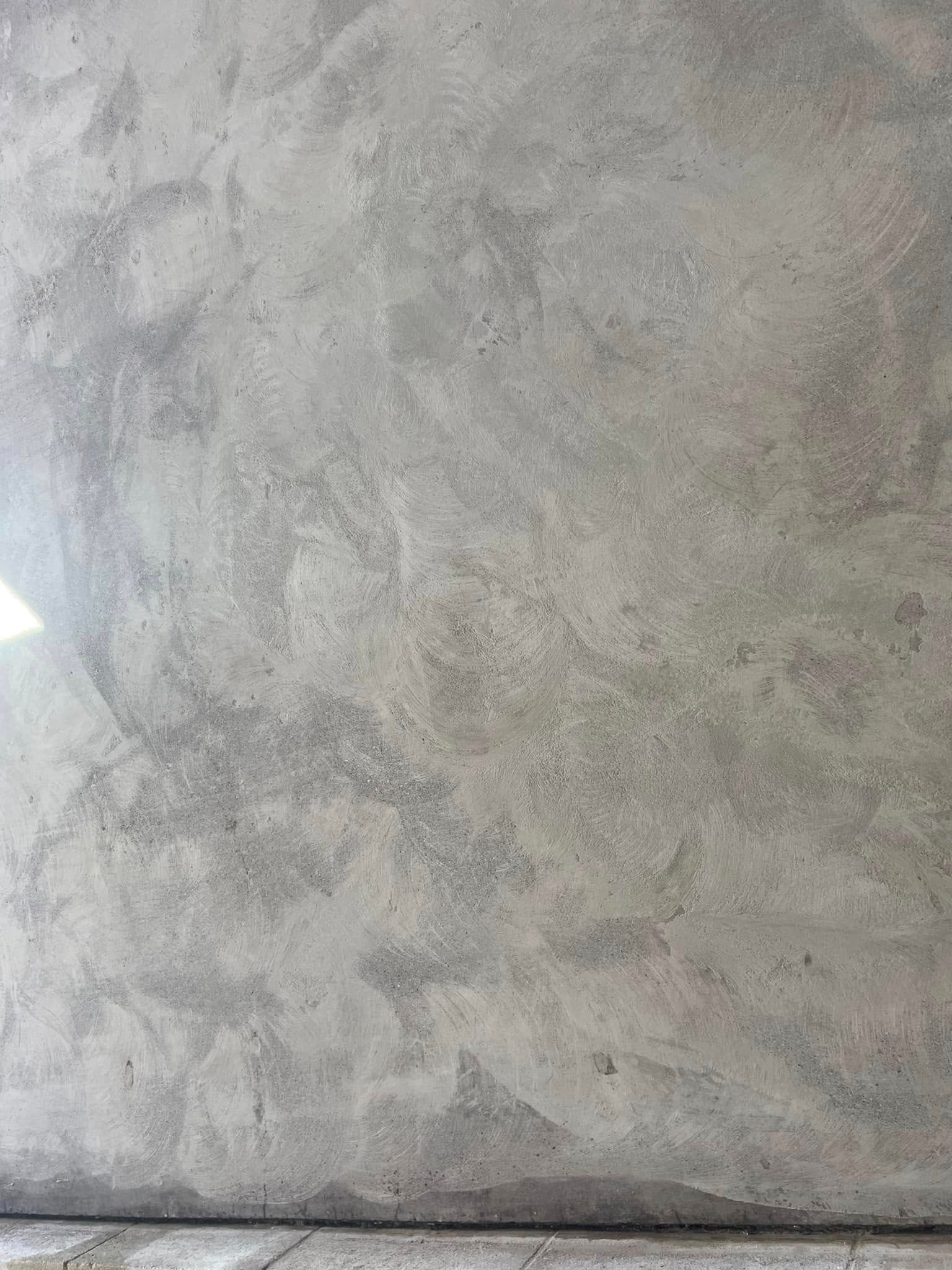Gray concrete surface with varying textures and tones, possibly a floor or wall.