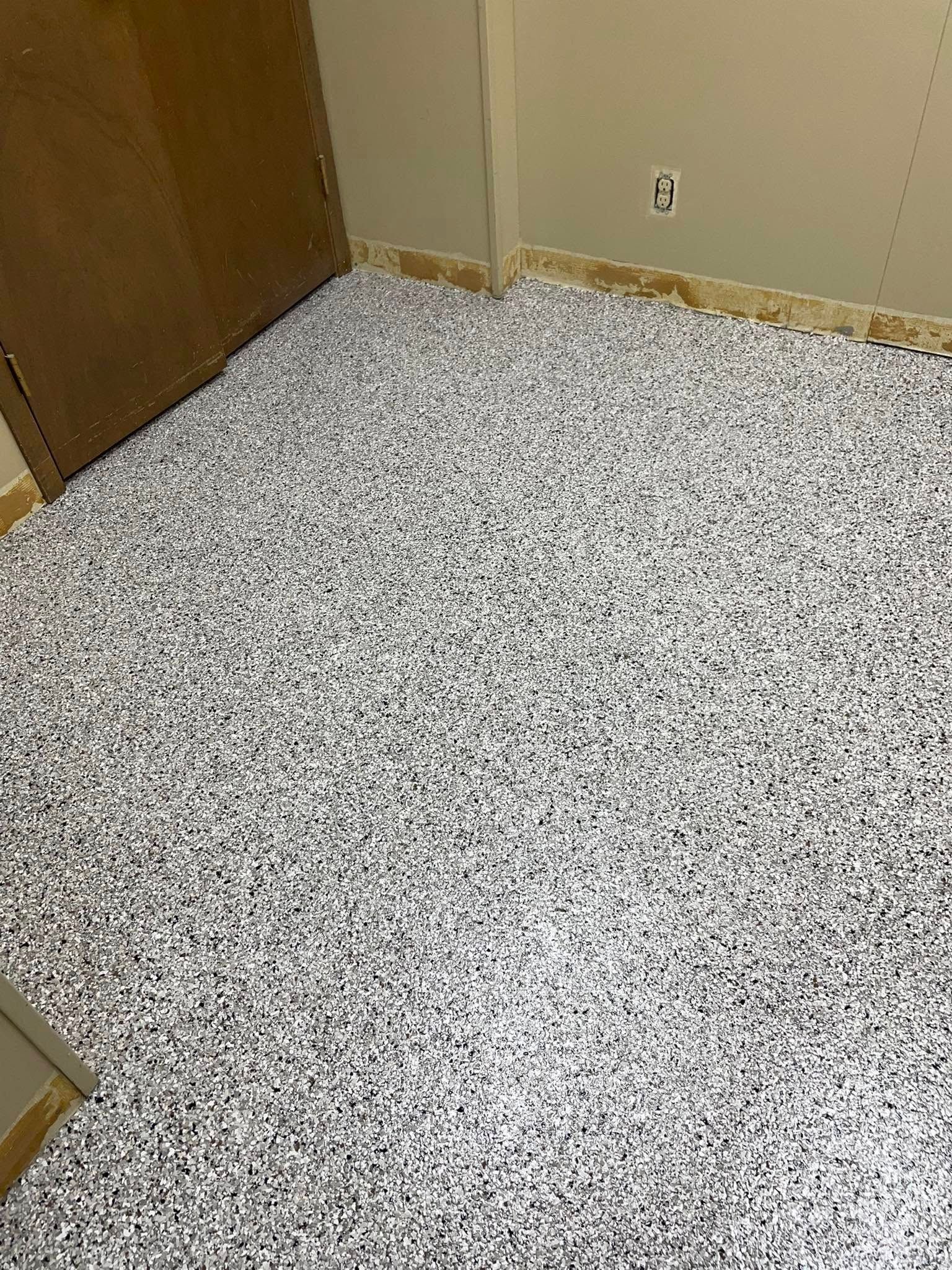 Room with a floor completely covered in shredded paper. Door and walls are visible.