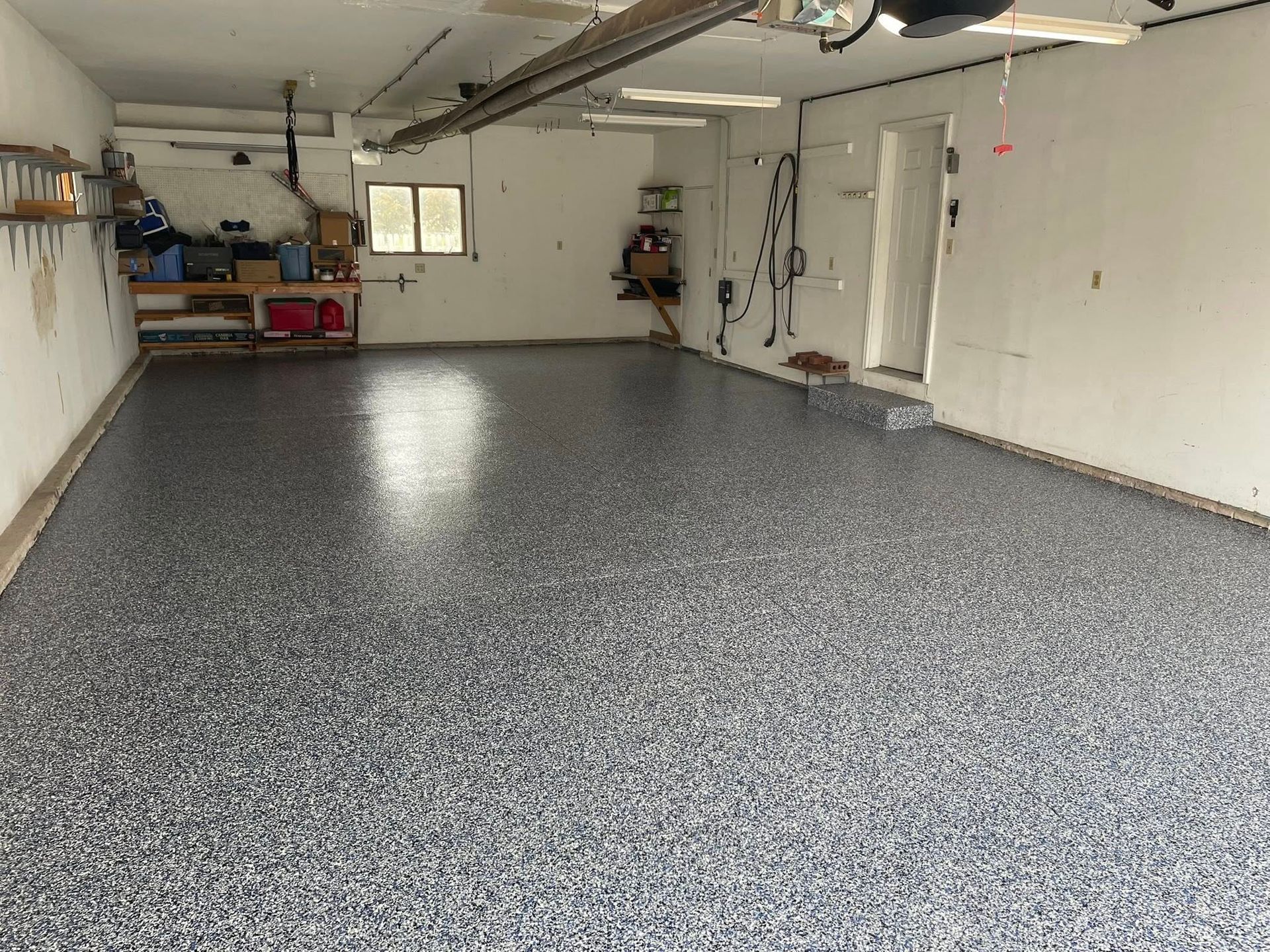 Garage with a speckled gray epoxy floor.