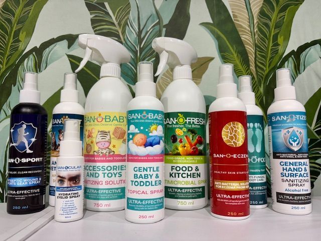 Assortment of SAN-O-BABY cleaning and sanitizing sprays in various colors, sizes and applications.