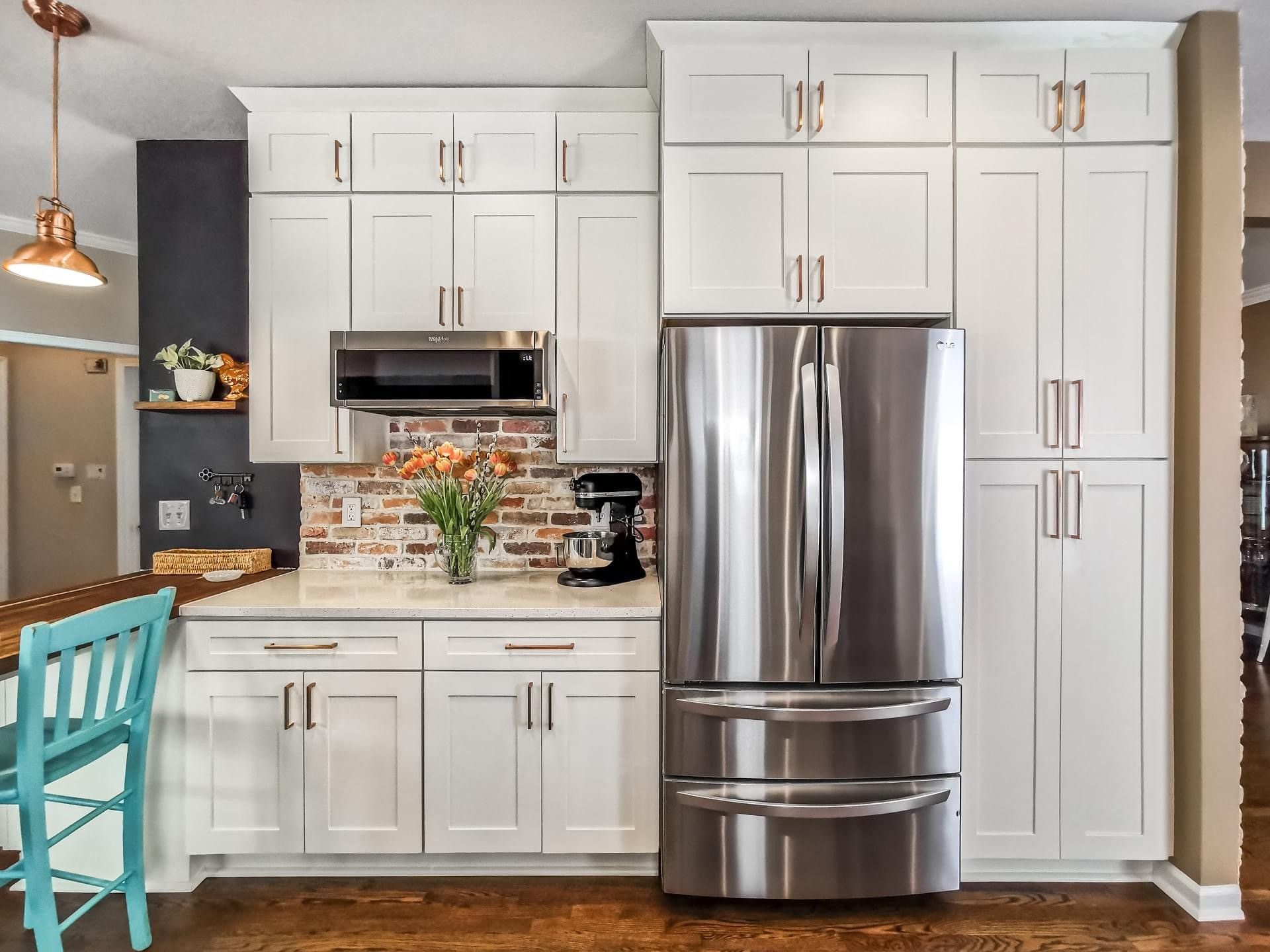 A kitchen with white cabinets and stainless steel appliances.