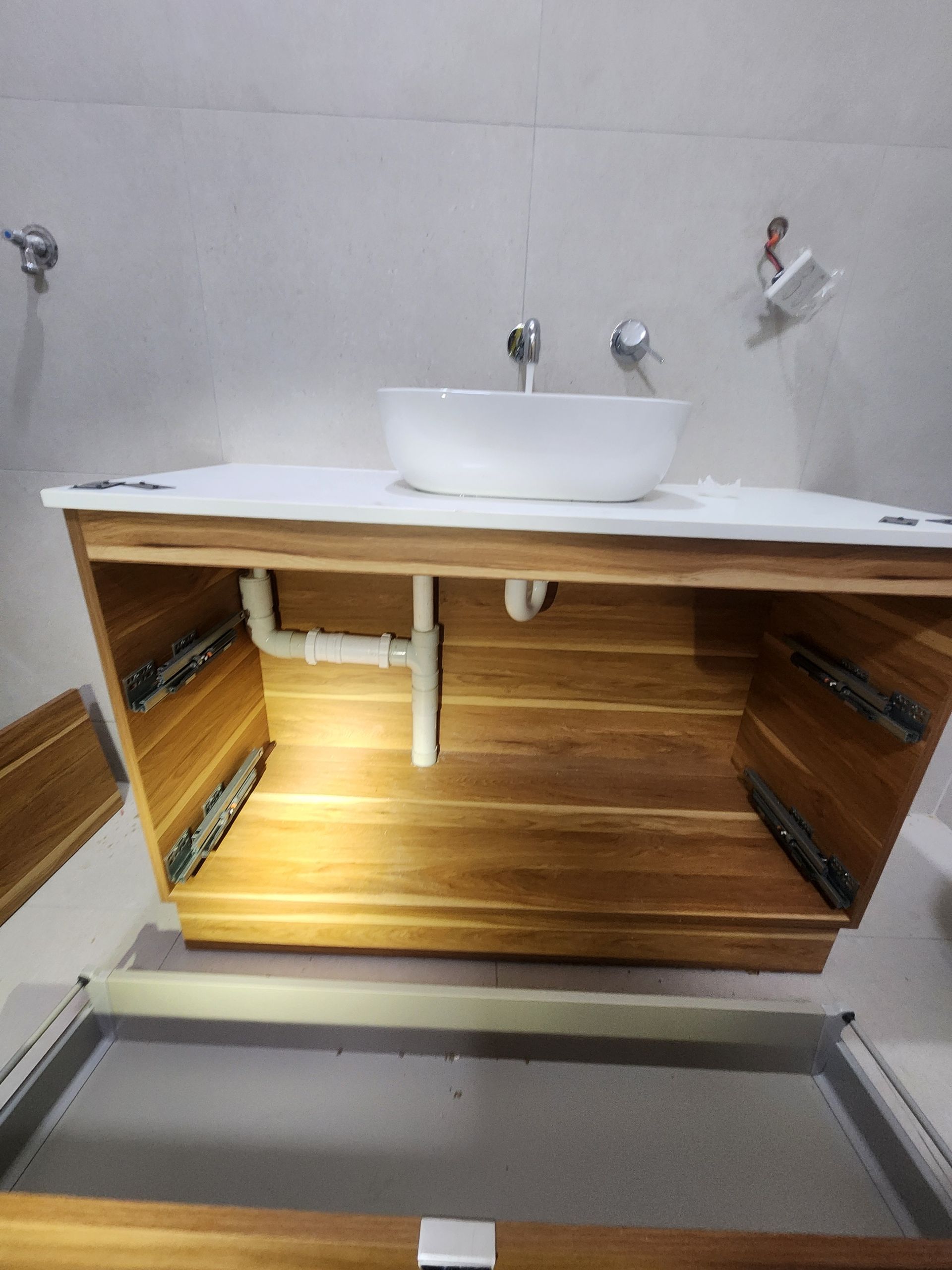 A White Toilet Sits in an Unfinished Room With Various Plumbing Tools — Kingdom Plumbing Services in Gordonvale, QLD