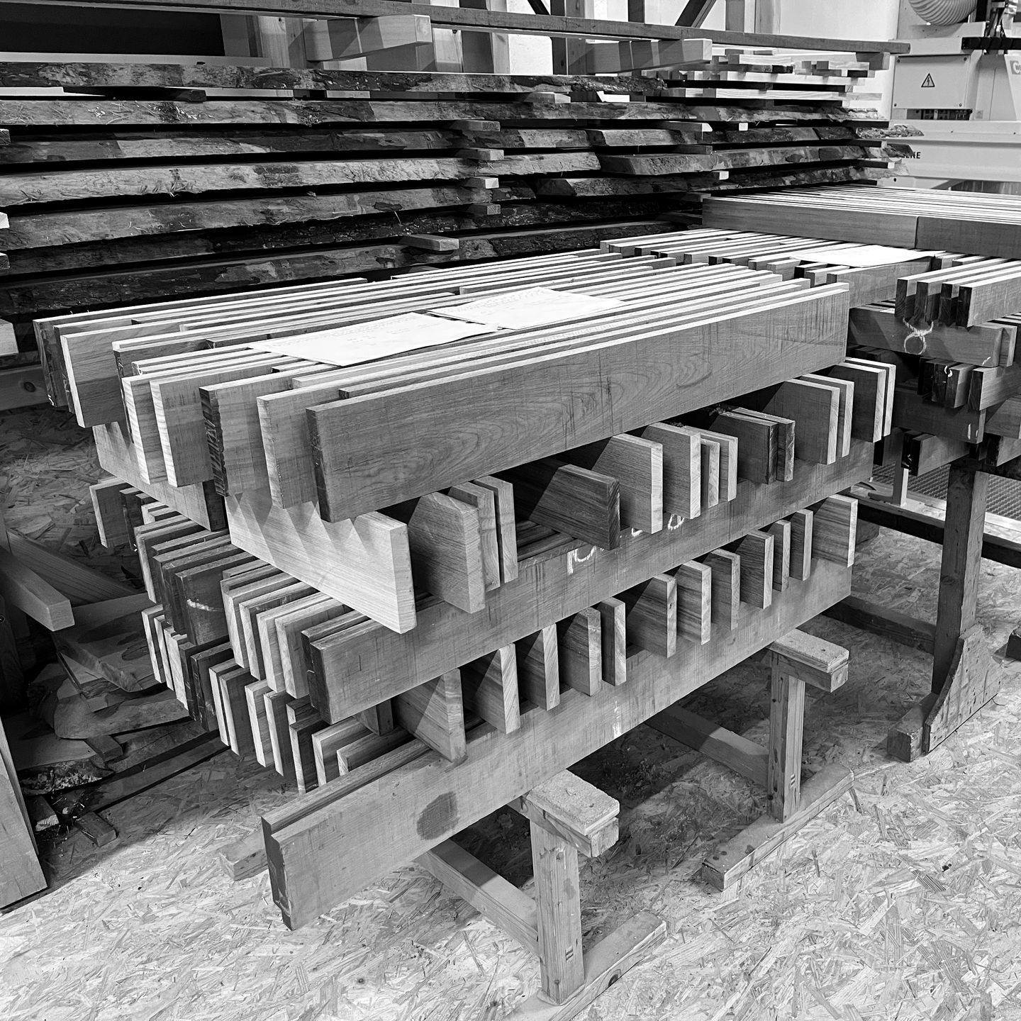 Weiße Glastüren öffnen sich zu einem lichtdurchfluteten Innenraum. Im Vordergrund stehen eine Stehlampe und ein Stuhl.