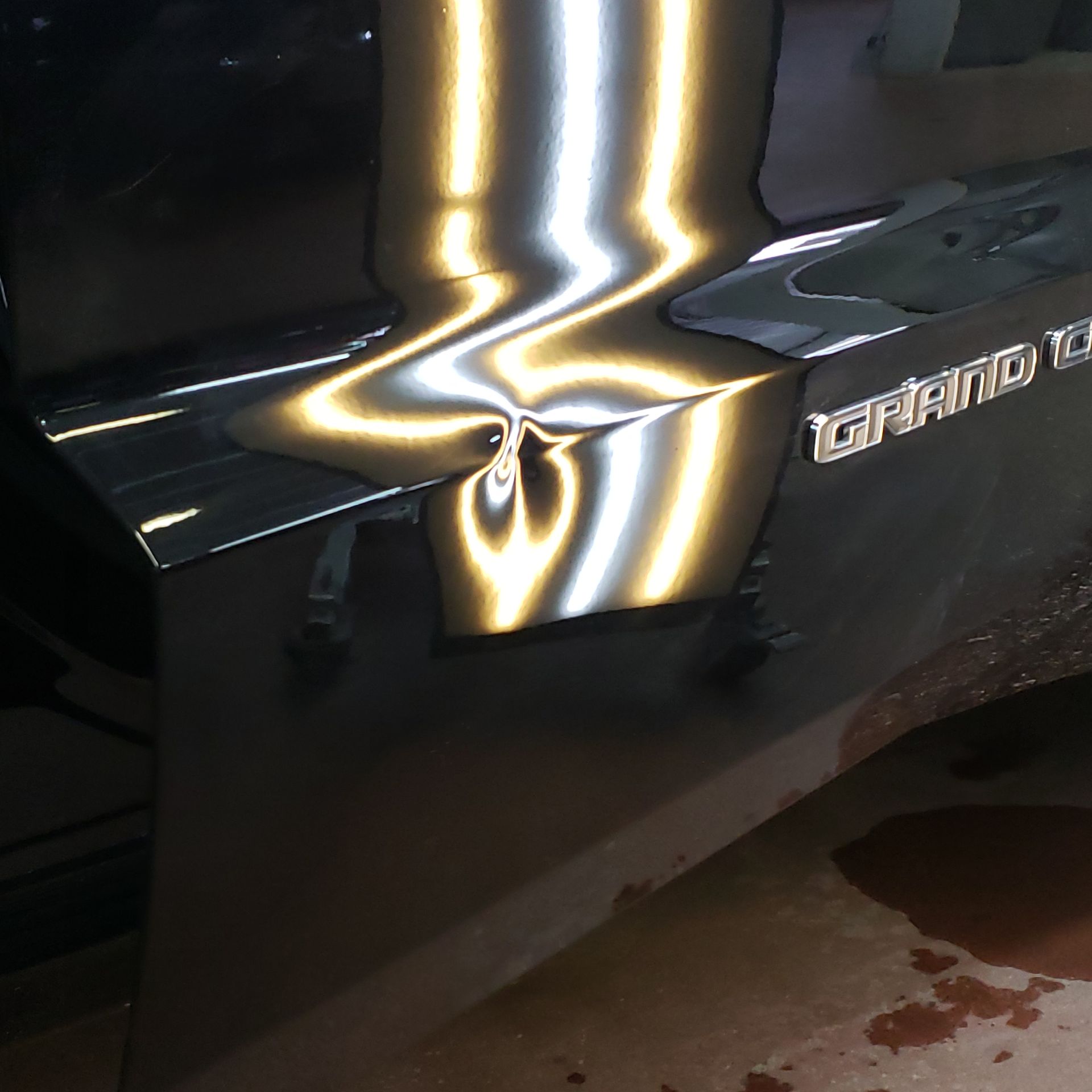 The word grand is on the side of a car