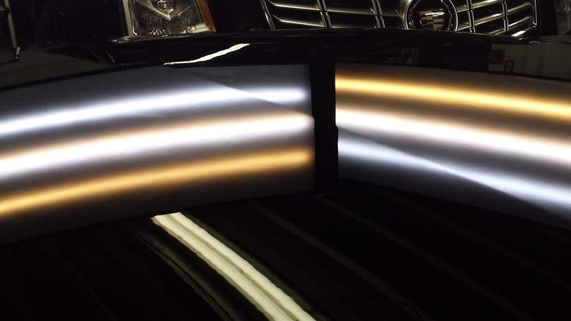 A close up of a car 's bumper with a dent in it.