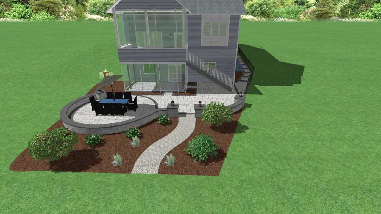 Two-story house with outdoor dining area, pathway, and landscaping on a grassy lot.
