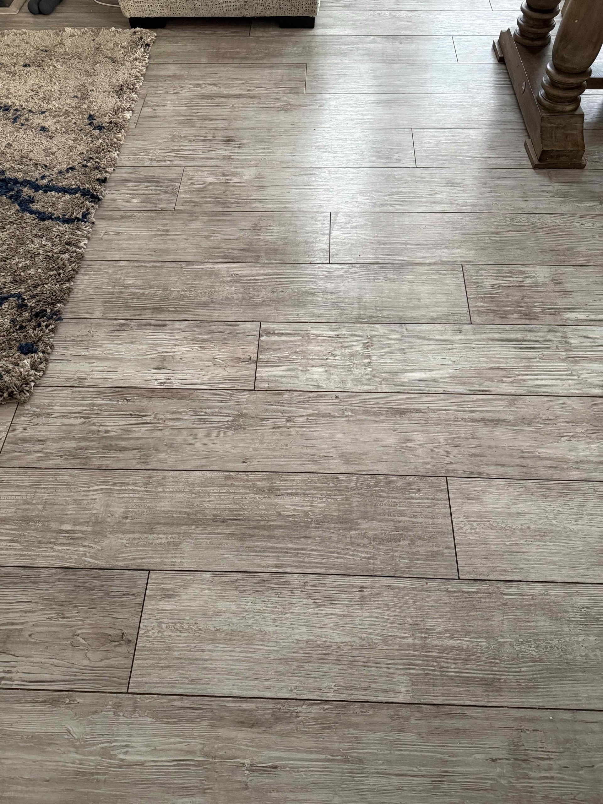 A close up of a wooden floor in a living room.