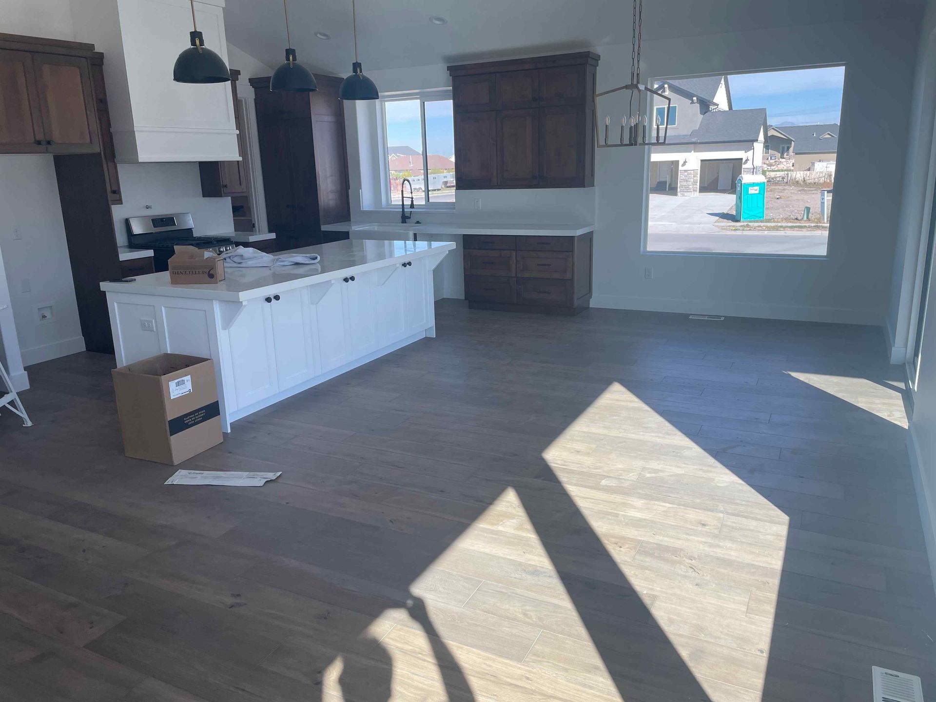 An empty kitchen with a large island in the middle of the room.