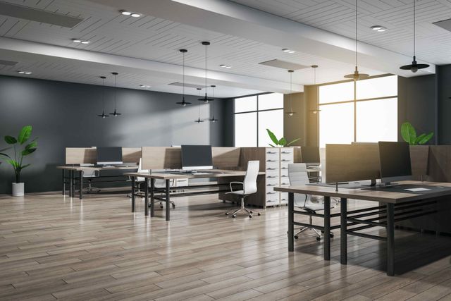 An empty office with a lot of desks and chairs.