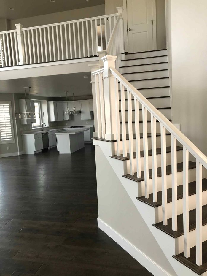 An empty house with stairs leading up to the second floor