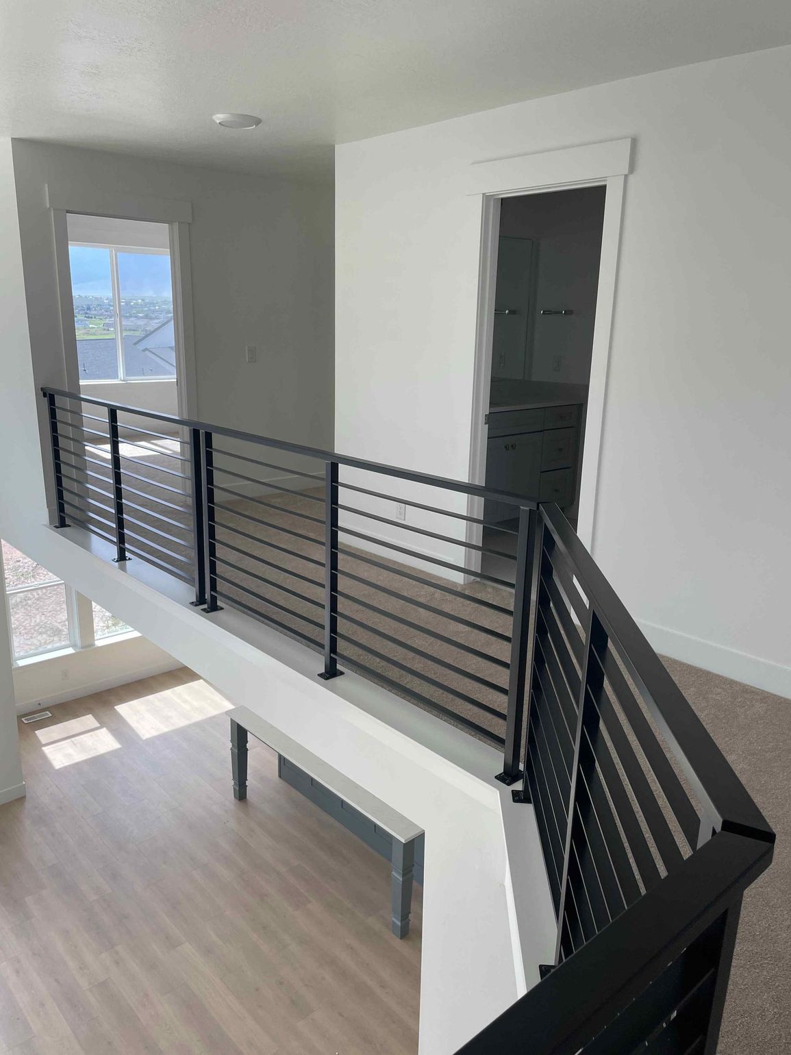 A view of a flooring installation staircase from the second floor of a house.