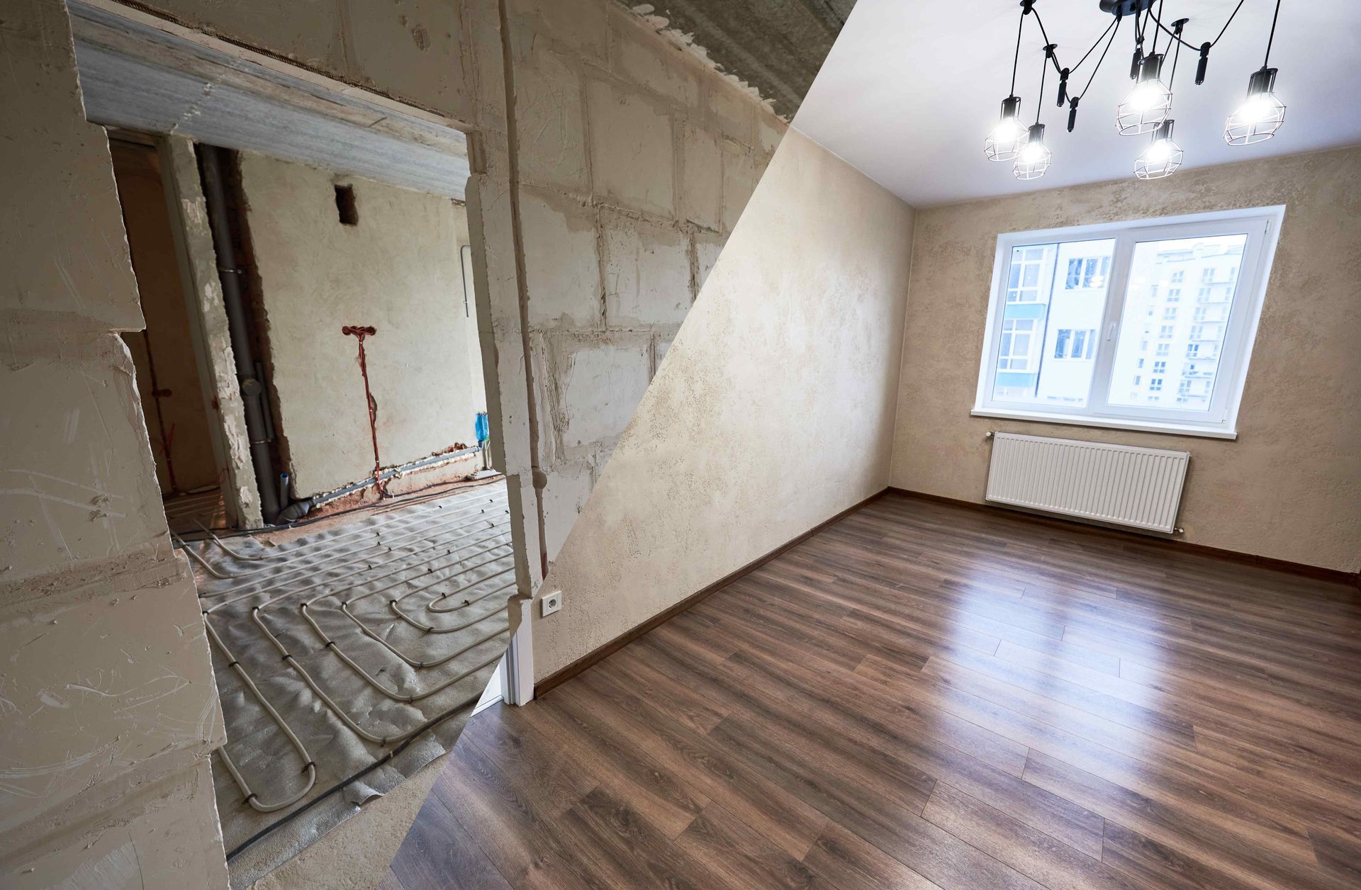 An empty room with wooden floors and a chandelier.