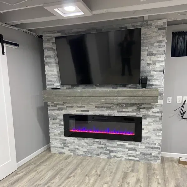A living room with a fireplace and a flat screen TV. A living room with a fireplace and a flat screen TV.