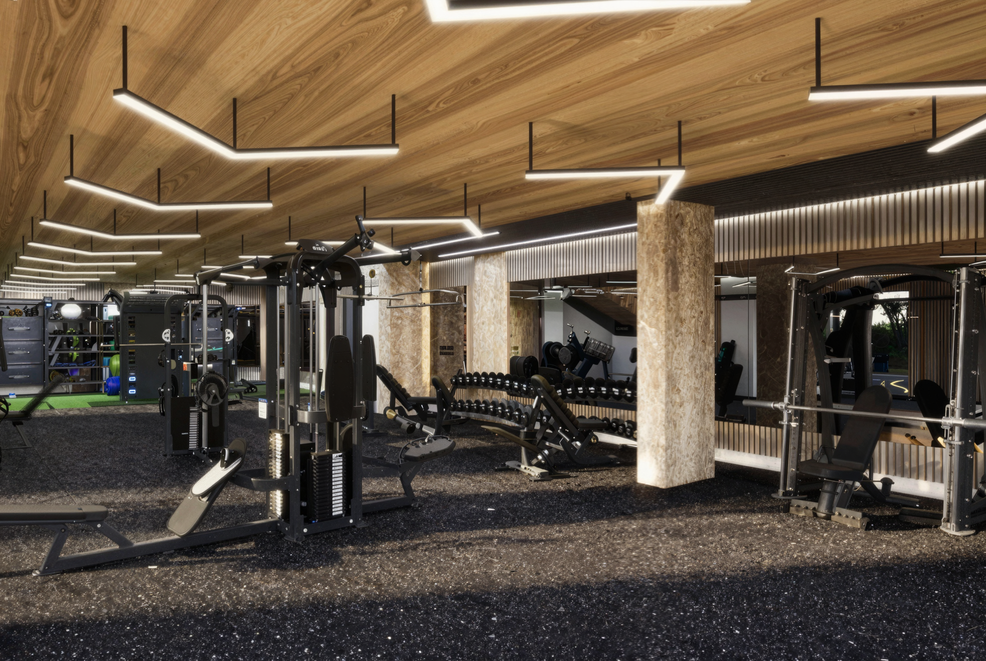 Gym interior with weight machines, benches, and dumbbells; wood ceiling and black speckled floor.