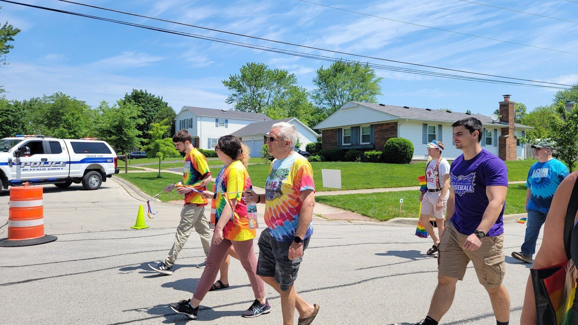 A group of people are walking down a street.