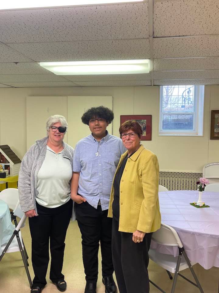 Three people are posing for a picture in a room.