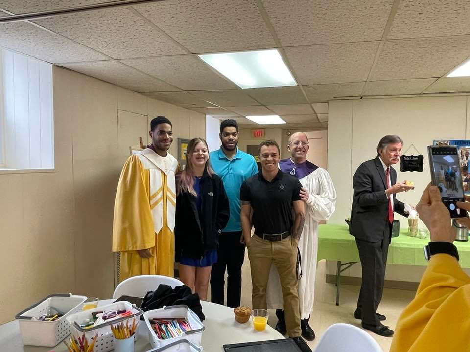 A group of people are posing for a picture in a room.