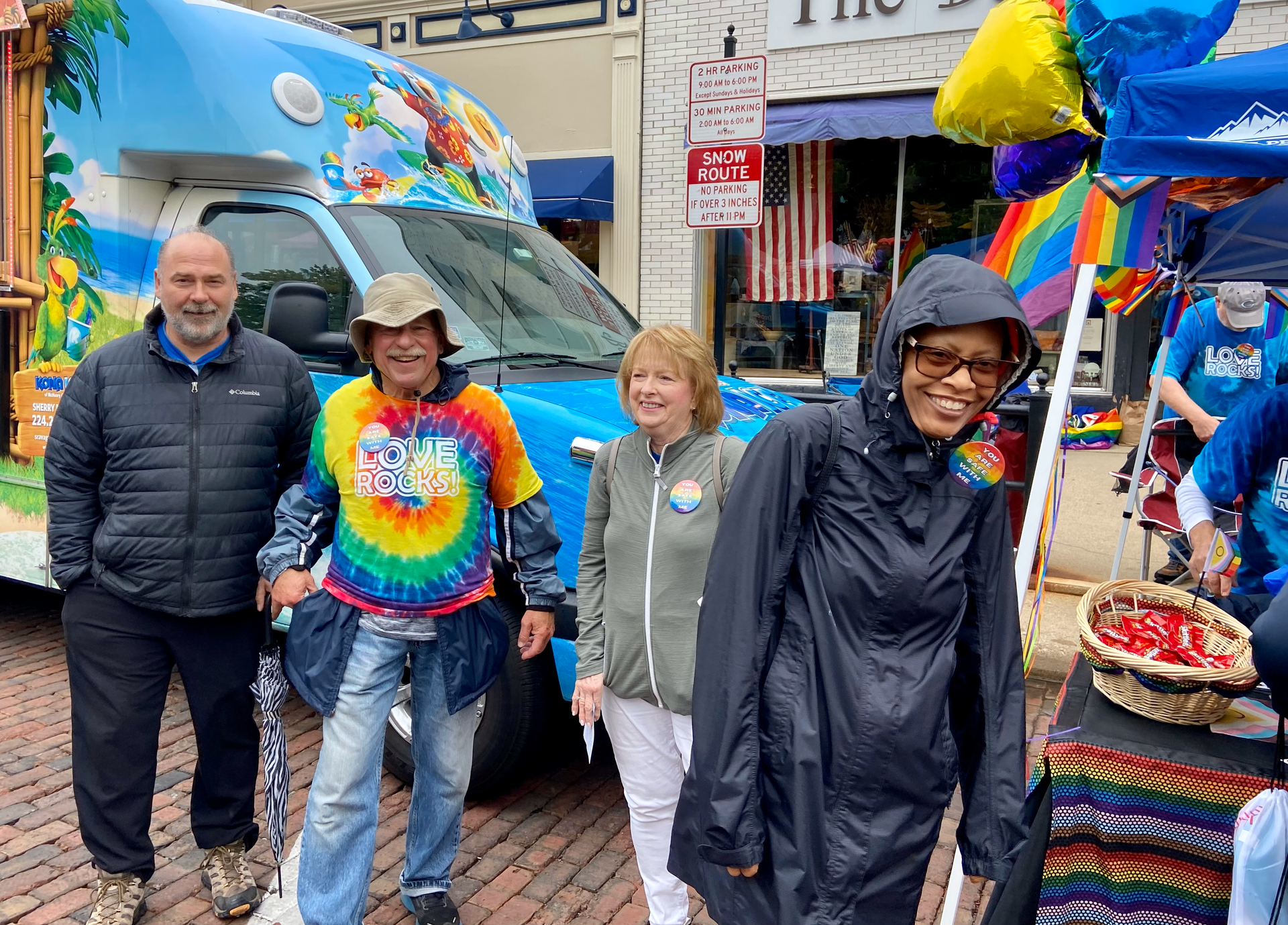 A group of people are standing in front of a food truck.