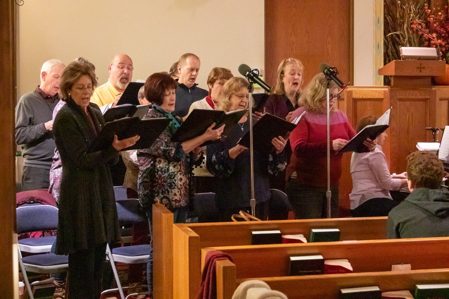 A group of people are singing in a church