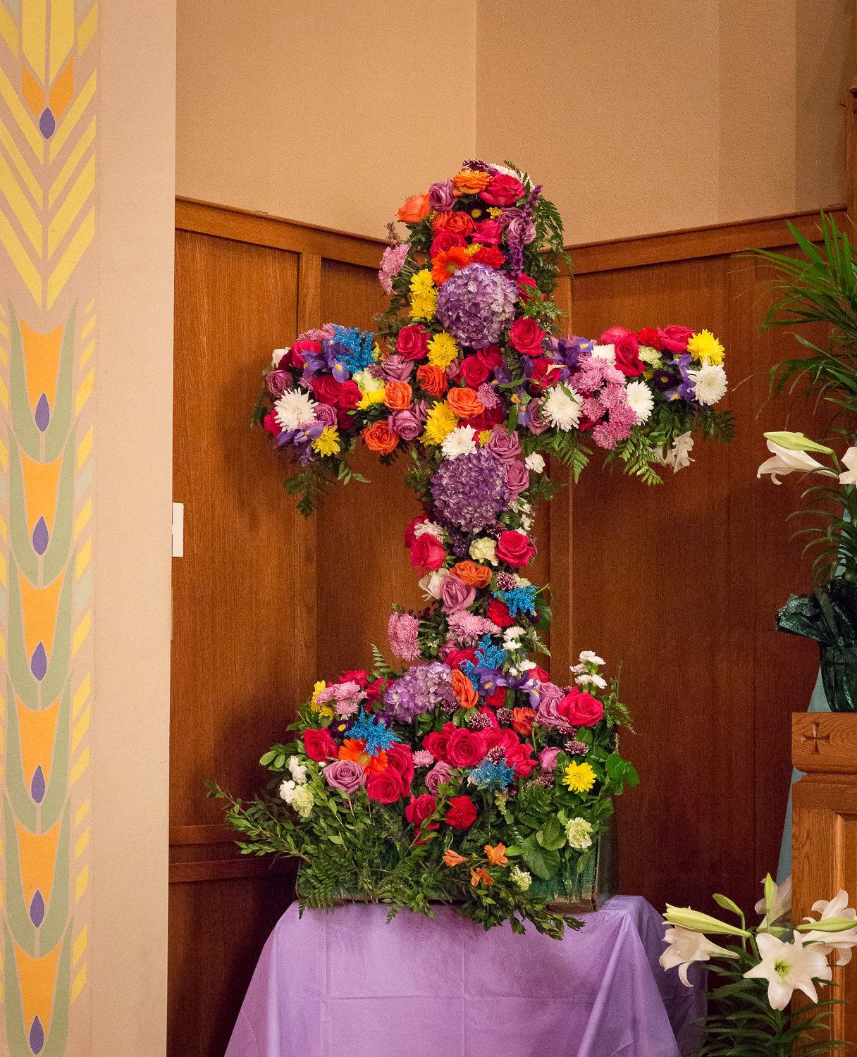 A cross made of flowers is sitting on a table