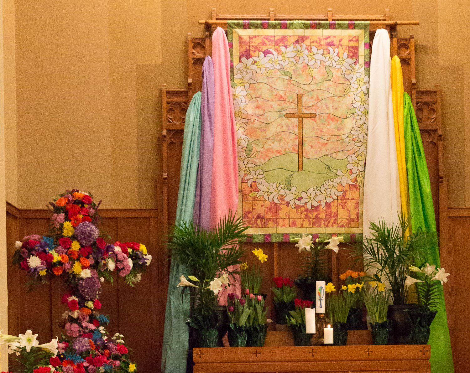 A church altar decorated with flowers and a cross
