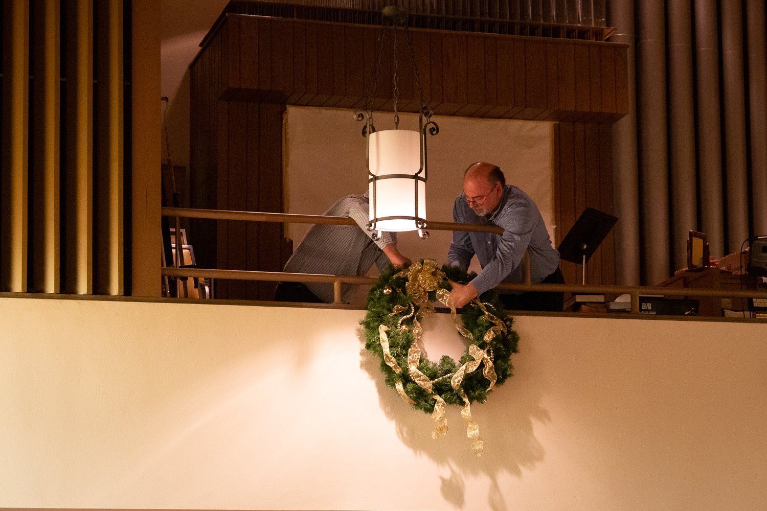 A man is decorating a wreath in a church