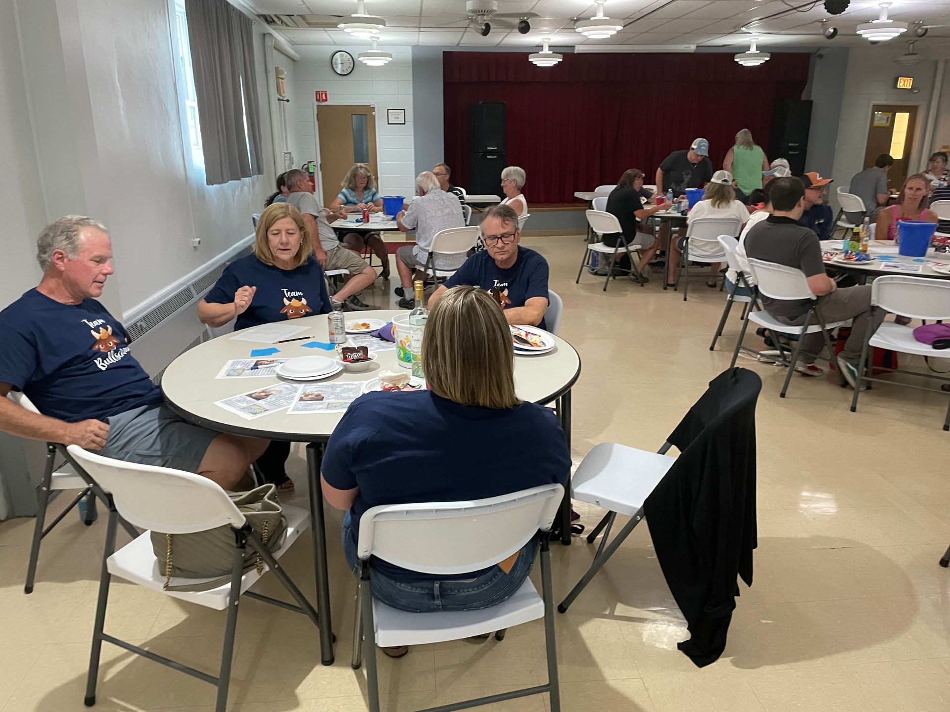 A group of people are sitting at tables in a room.