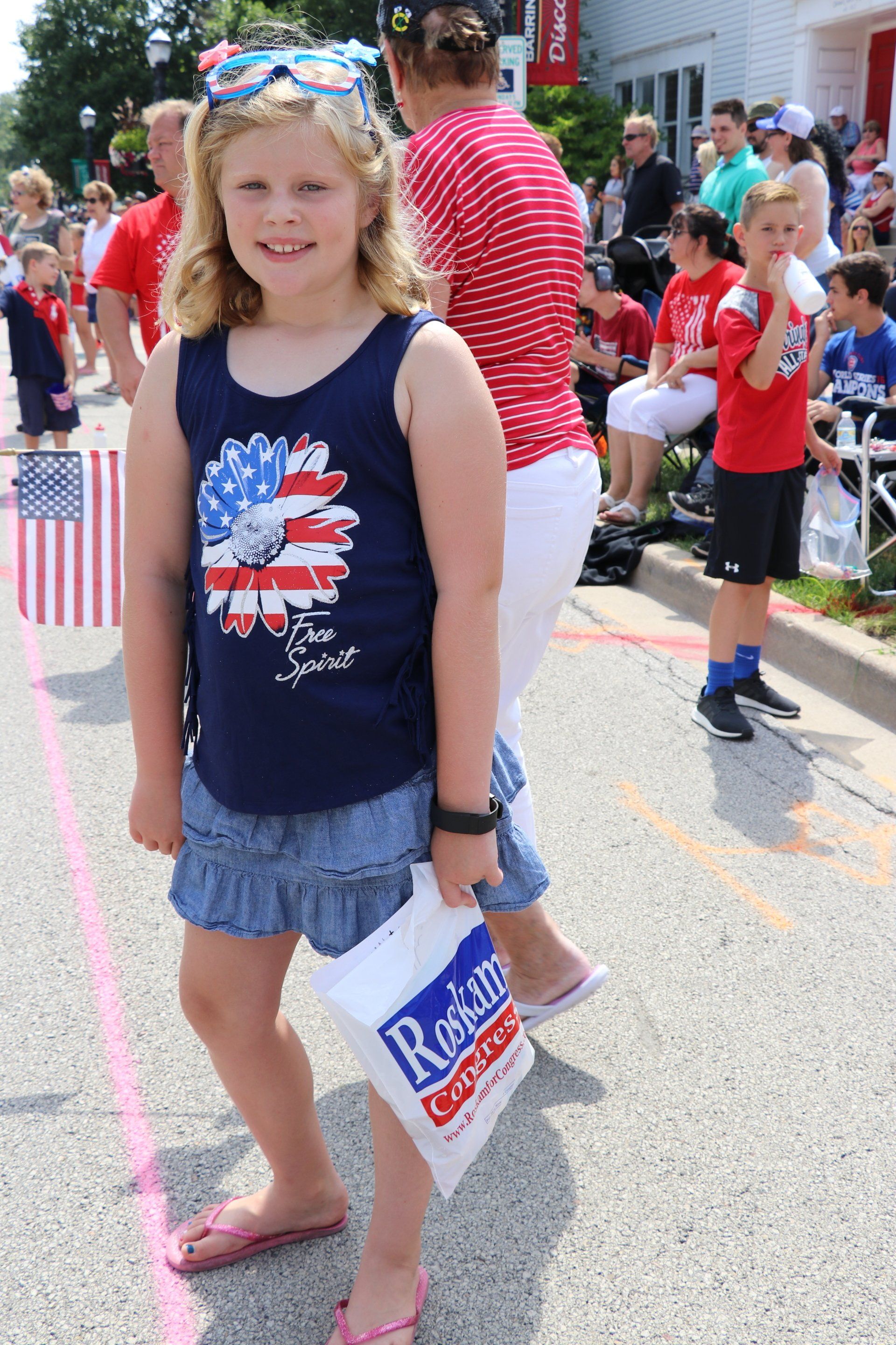 A little girl is holding a sign that says rosie 's
