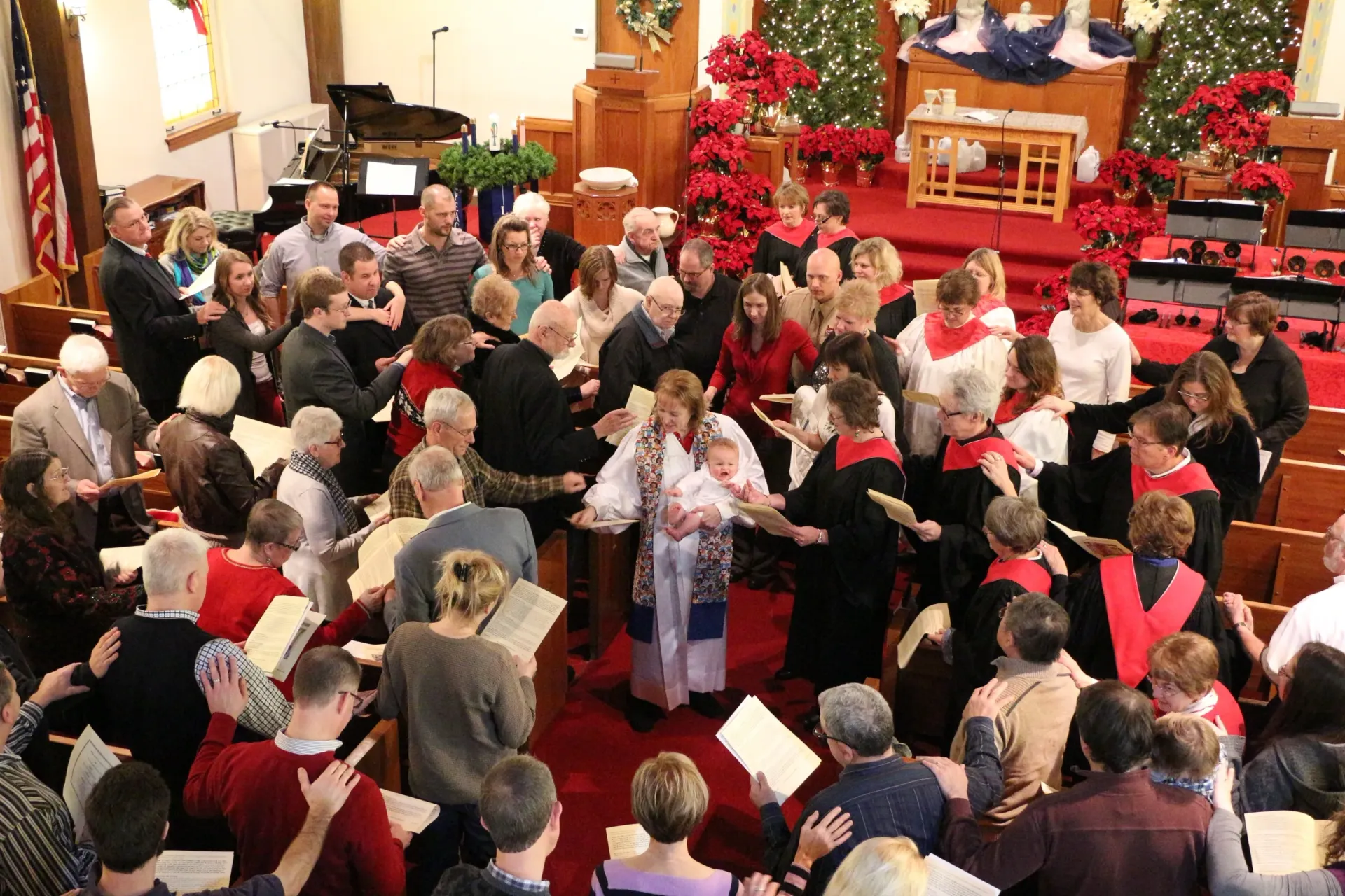 A large group of people are singing in a church.