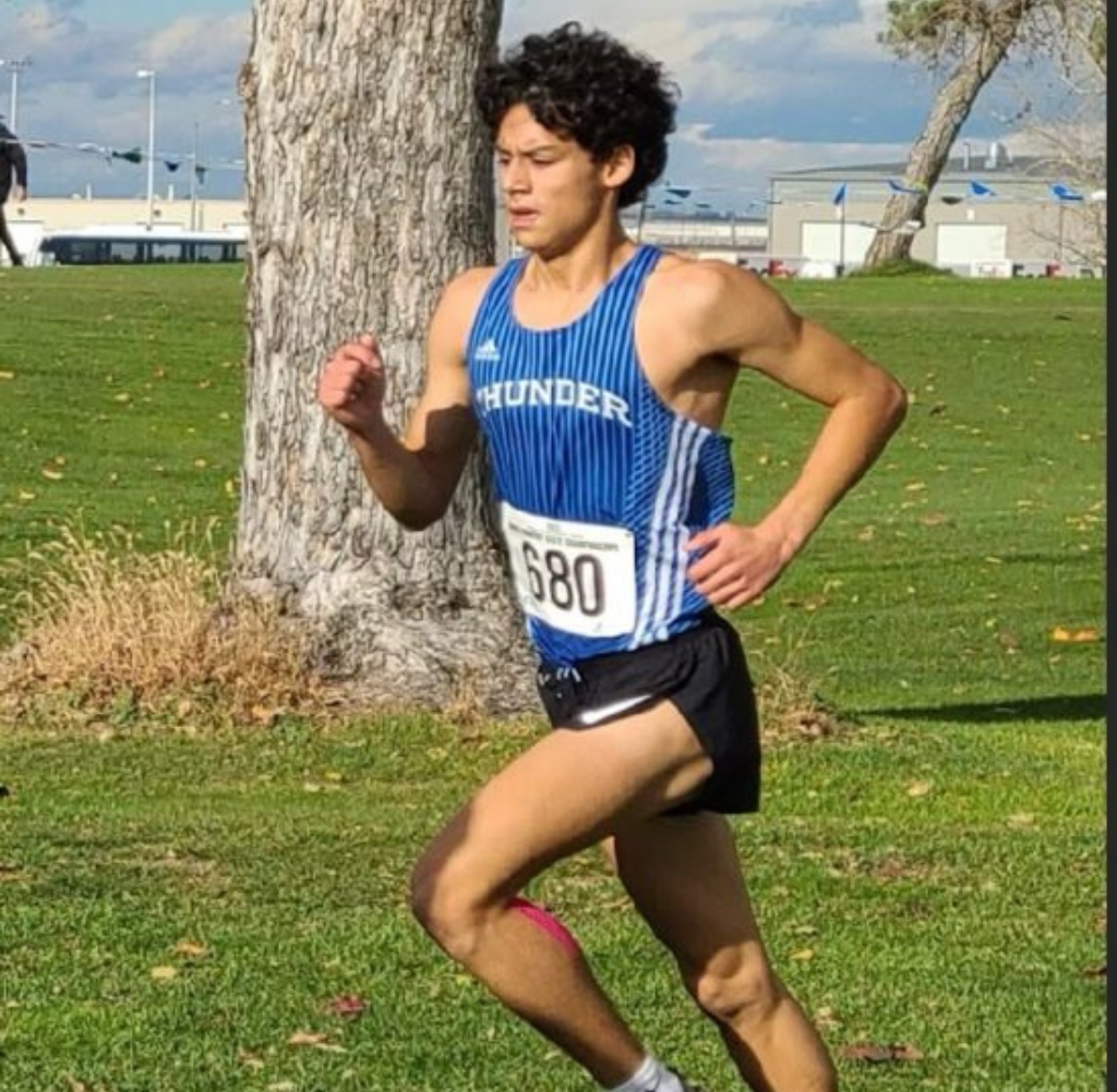 Mountain View High School Male runner in blue Thunder jersey with number 680 on a cross-country course.