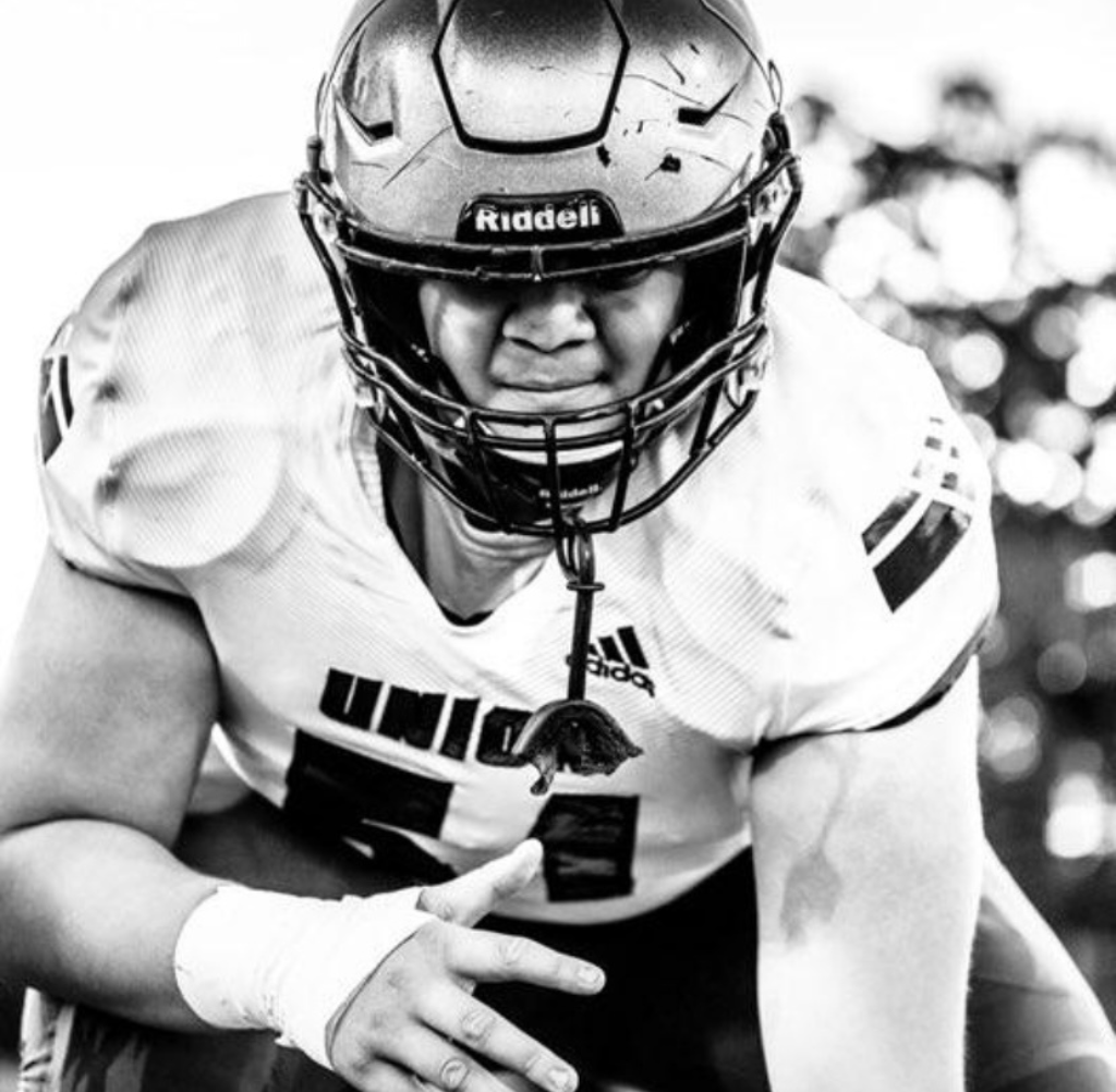 Union High School Football player in uniform, crouched low, ready to play. Black and white photo.