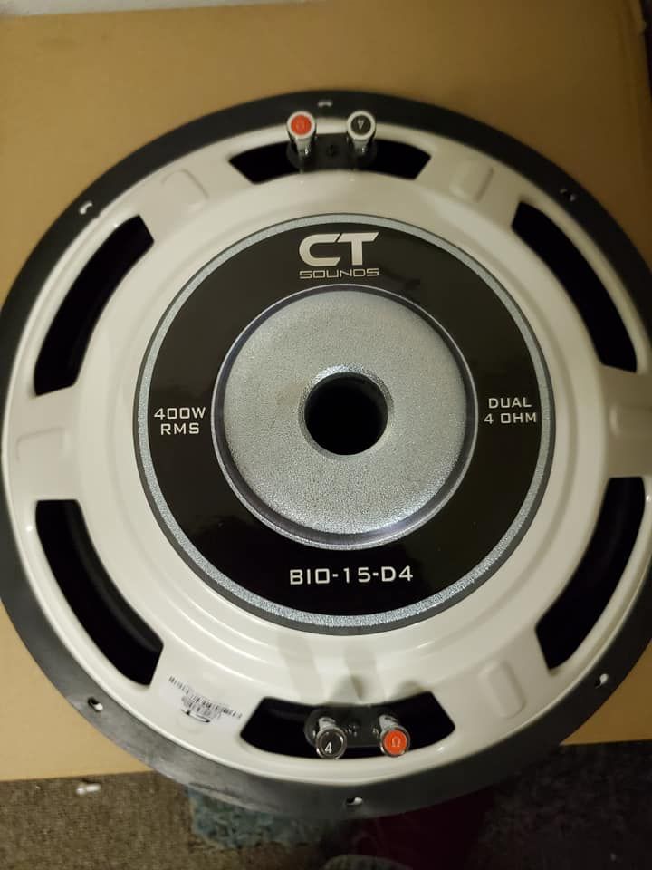 A CT Sounds subwoofer, viewed from above. It has a white cone, black trim, and dual 4-ohm terminals.
