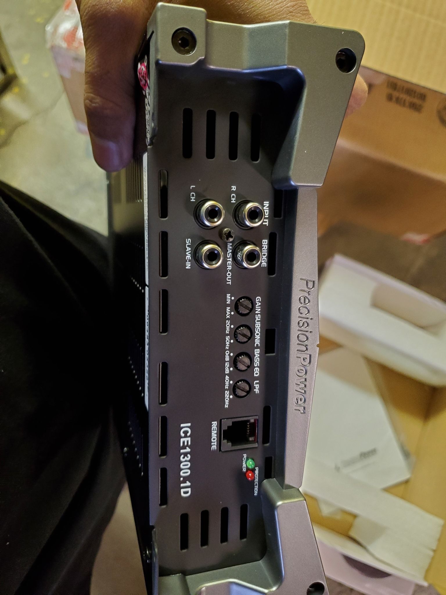 Top view of a Precision Power ICE120.4D car audio amplifier with ports and connections visible.