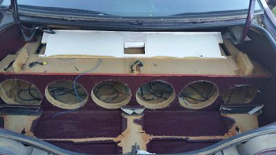 Interior of a car trunk with a custom subwoofer enclosure. 