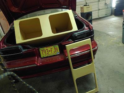A car trunk with a custom speaker box installation. 