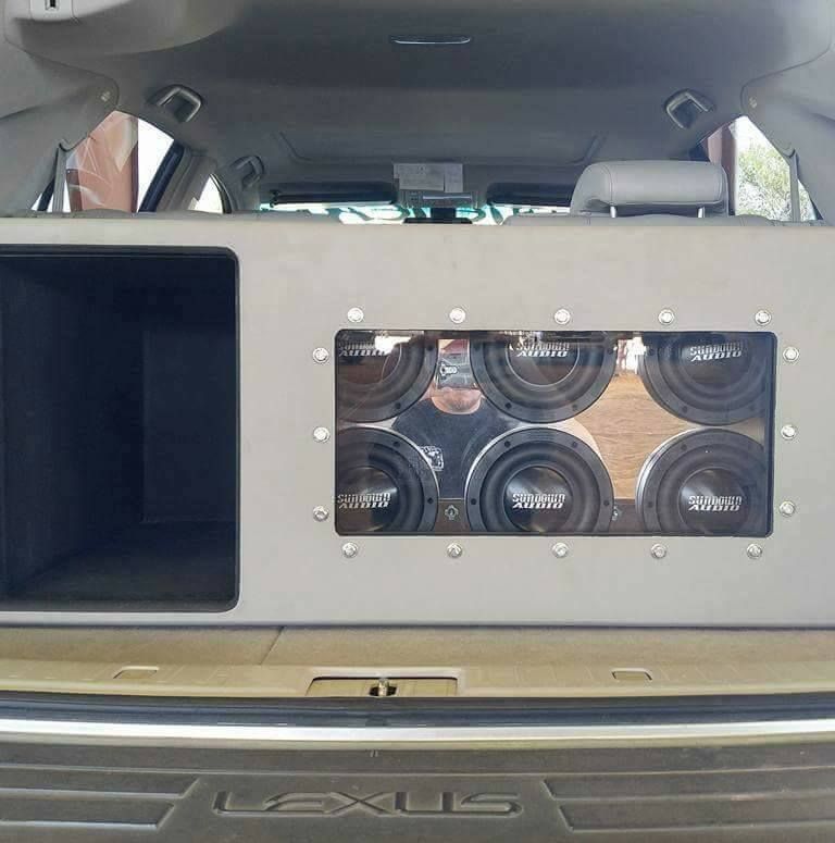 A car trunk with custom speaker system housing six subwoofers.