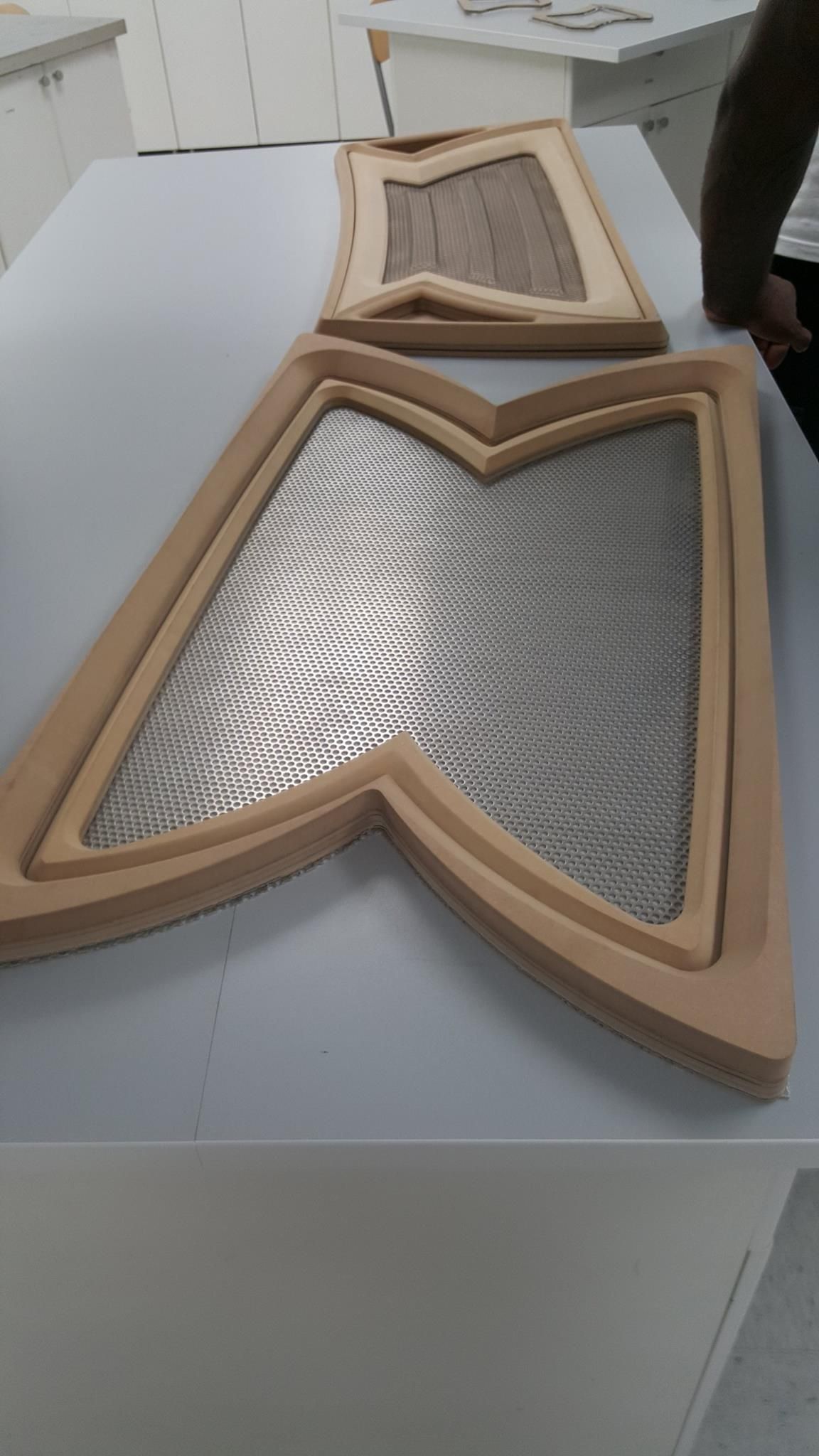 Two decorative wooden frames with metal mesh inserts, on a white surface.