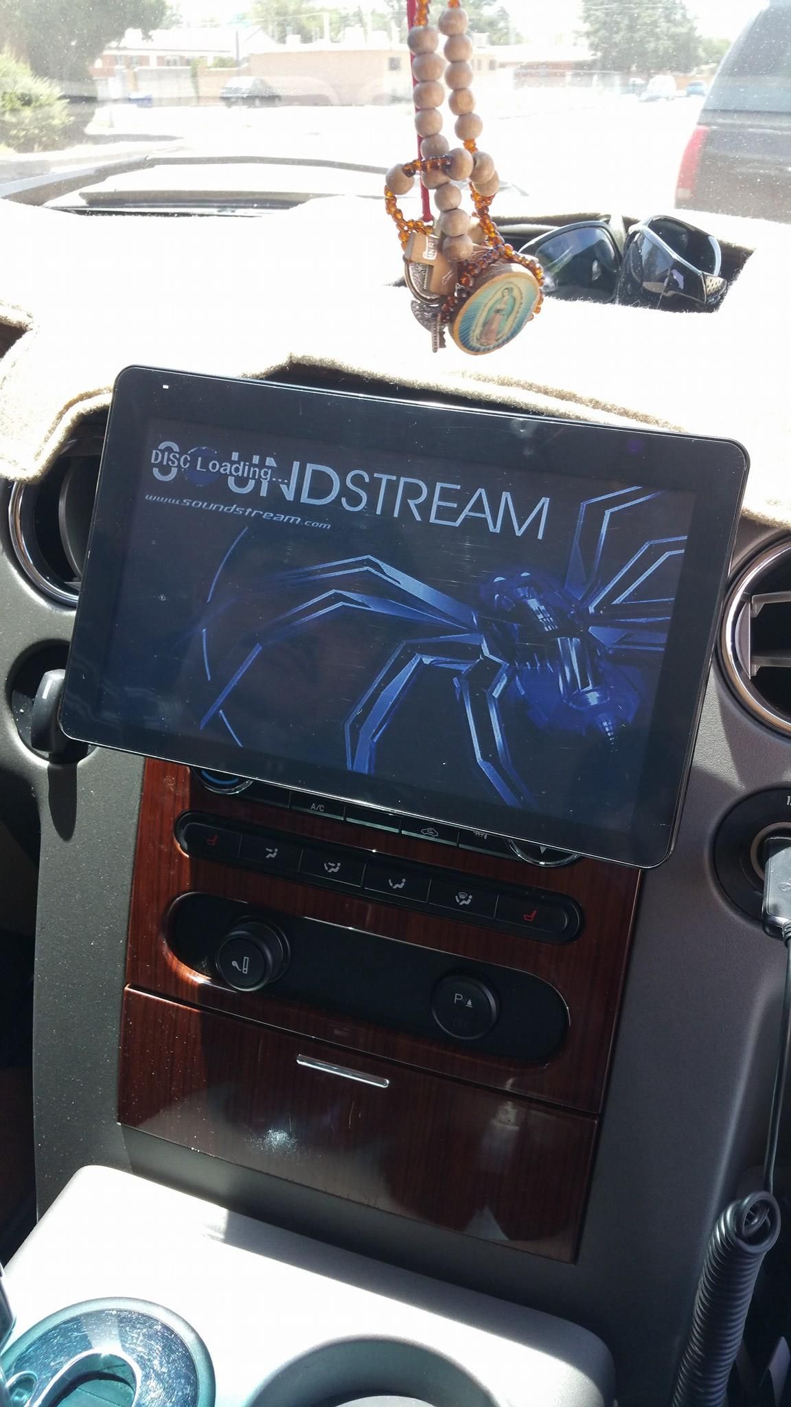 Interior car dashboard with a tablet displaying 